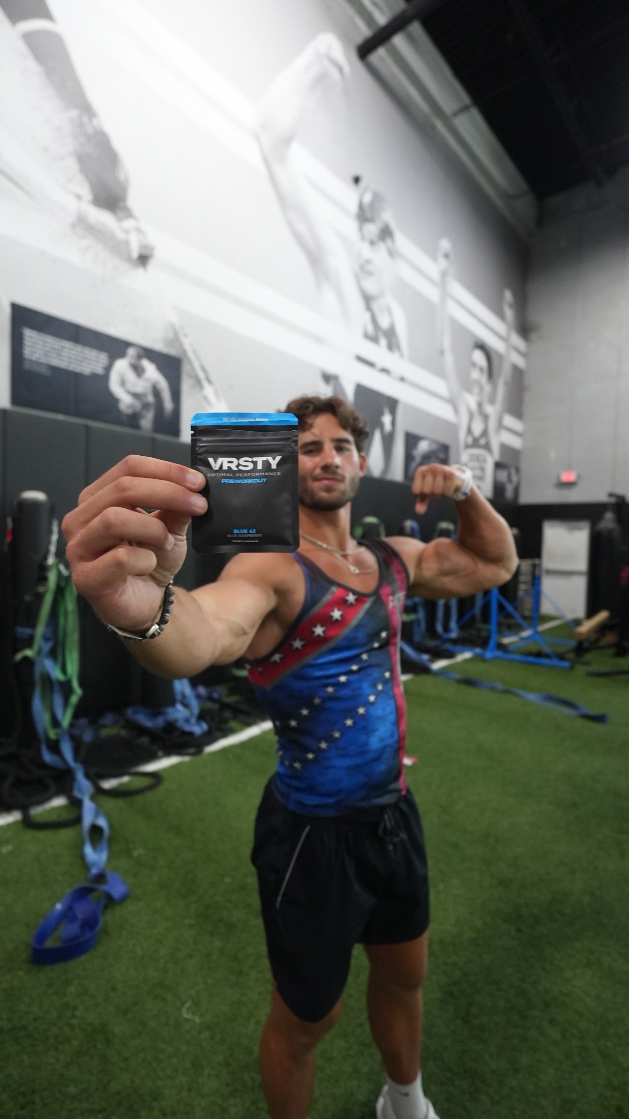 Athlete holding a VRSTY Pre Workout sample packet before training